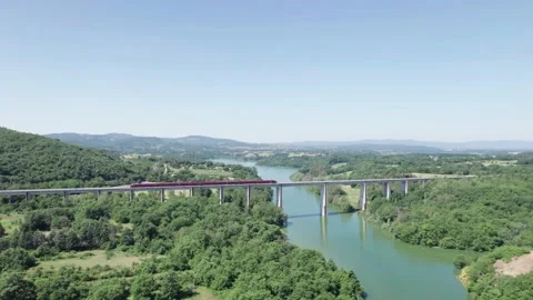Aerial flight 4K pan view rail bridge Italo NTV Alstom Train passes by Tuscany 스톡 동영상 196233498