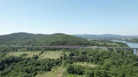 Aerial flight 4K view rail bridge Freccia Rossa ETR 1000 Train passes by pan Stock-Footage 196233501