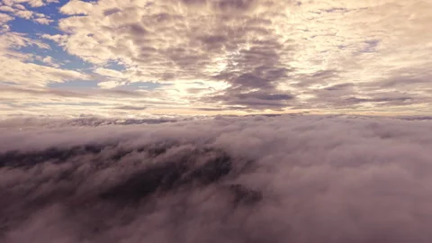 Aerial Flight Above Clouds and Mist at Sunrise Video stock 320045180