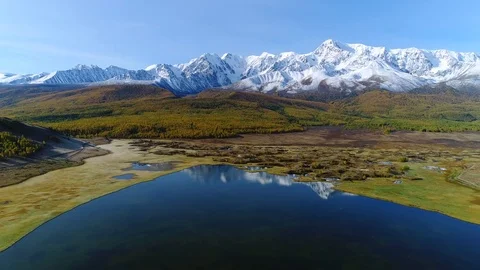 Aerial flight above mountains mirrored in the lake Stock-Footage 80383602