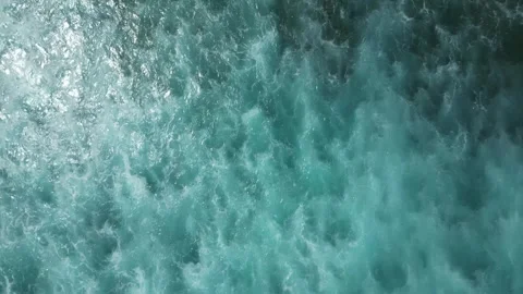 Aerial flight above powerful turquoise ocean waves, sunlight sparkling on water, Stock Footage 320535534