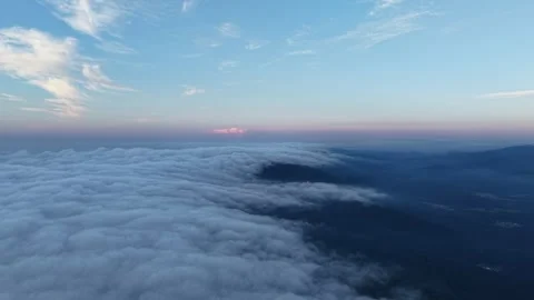 Aerial Flight Above Sea of Clouds and Mountains at Twilight Stock Footage 344329767