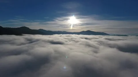 Aerial flight above the sky in mountains with a dip in the clouds 库存影片 80595545
