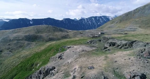Aerial flight above wooden farm in Altai mountains Stock Footage