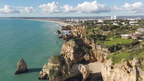 Aerial Flight Along Dramatic Algarve Cliffs with Alvor in Background Stock Footage 329161670