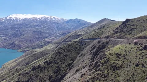Aerial Flight Along Mountain Cliffs Toward River Road Video stock 345484908