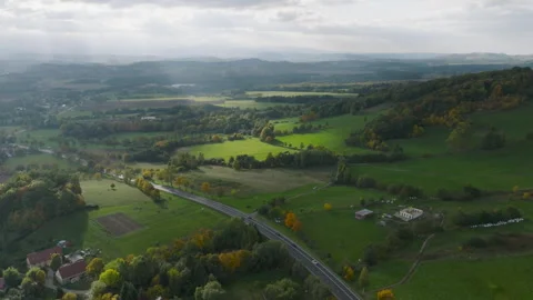 Aerial flight along a road through autumn hills near Radomierz Stock Footage 346658634