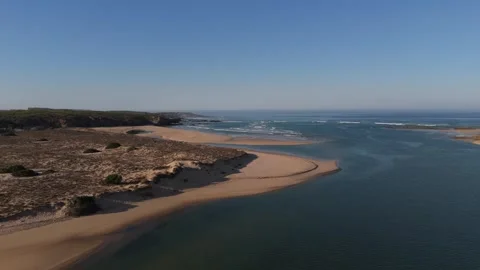 Aerial flight along sand dunes and the Mira River toward the ocean, Portugal Stock Footage 346373497
