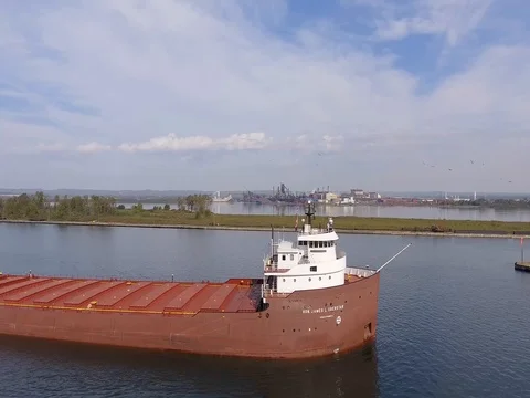Aerial flight alongside freighter on St Marys River Stock Footage 80896725