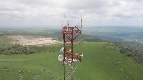 Aerial flight around the telecom tower installed on the top of the hill Stock Footage 155759737