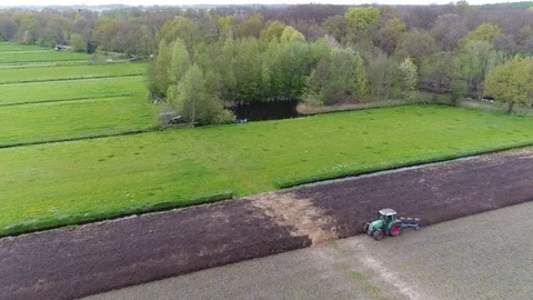 Aerial flight backwards over different landscapes starting in small pond 4k Stock Footage 75352952