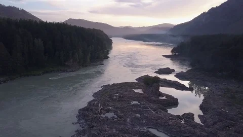 Aerial flight backwards under rapid mountain river Katun and many islands. Altai Video stock 84575993