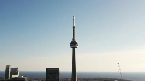 Aerial flight backwards while zooming in on the CN Tower to give off a beautiful Stock Footage 151921587
