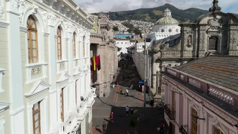Aerial Flight Between Banco Central and Compania de Jesus Along Historic Street Stock Footage 331900655