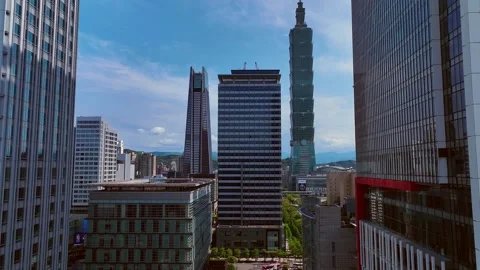Aerial flight between skyscraper building in Taipei City Downtown and 101 Stock Footage 244038813