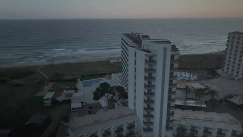 Aerial Flight Between Two Hotels Toward Son Bou Beach at Sunset Stock Footage 344438272