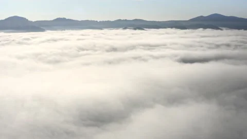 Aerial flight beyond sky over morning fluffy clouds high in the mountains Stock Footage 196728735