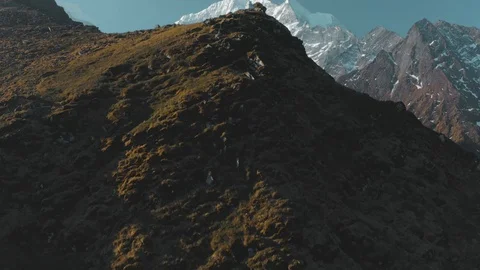 Aerial flight to building on mountain top and snow peak of Everest mountain o Vídeos de archivo 114882759