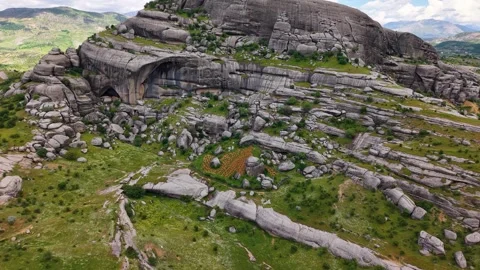Aerial Flight Close to Giant Rock Revealing Lush Green Valley Video stock 344330812