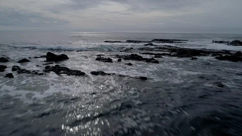 Aerial flight close to surface of ocean towards horizon Stock Footage 98381236