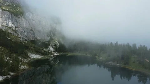 Aerial flight in the clouds over a lake Stock Footage 169286152