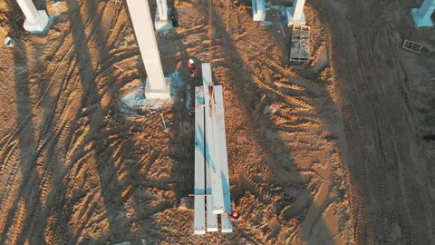 Aerial flight on construction site. Workers in hardhat protection wear Stock Footage 163225602