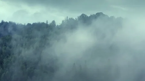 Aerial flight deep inside clouds high above mountain tops. Misty mountain Stock Footage 135168657