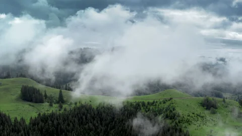Aerial flight deep inside clouds high above mountain tops. High peaks covered by Stock Footage 135323636
