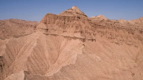Aerial flight in the desert over sharp sandy cliffs, mountains. Stock Footage 105905910