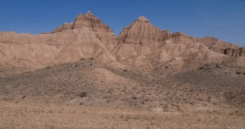 Aerial flight in the desert over sharp sandy cliffs, mountains. Stock Footage 105905988