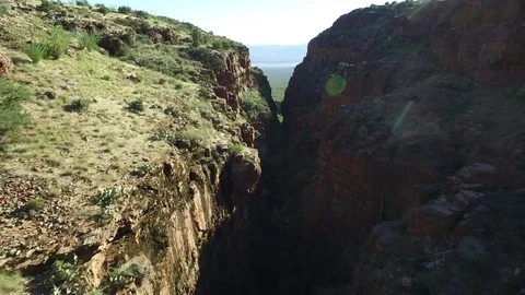 Aerial Flight Down Narrow Desert Canyon to Open Majestic Southwest Lake Scene Stock Footage 79606931
