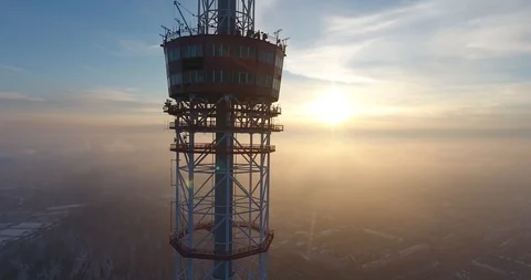 Aerial flight of the drone moving down the TW tower during the sunset over the Stock Footage 85900173