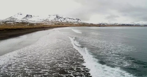 Aerial flight with drone over the black sandy beach of Brimilsvellir of Icela Stock Footage 77075385