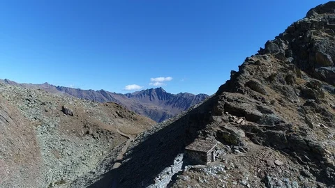 Aerial flight with drone over First World War military walls in the Italian Alps Stock Footage 99728946