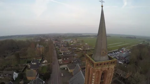 Aerial flight dusk time moving counter clock wise around church tower 4k Stock Footage 61156422