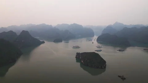 Aerial Flight Establish Ha Long Bay Rugged Rock Isles and Anchored Cruise Ships Stockbeeldmateriaal 335180664