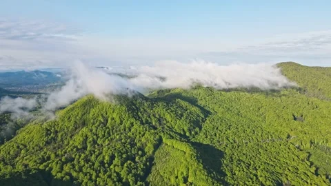 Aerial Flight Flight over the top of a mountain covered with clouds. A mountain Stock Footage 157669358