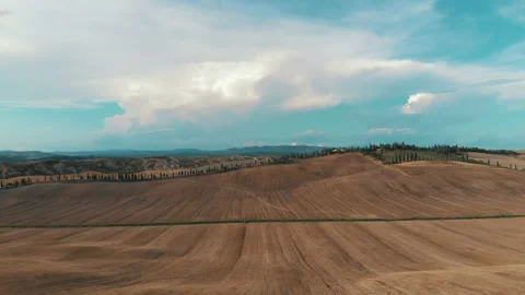 Aerial Flight forward Fly Tuscany Fields, cypress Nature Sky Farm Agriculture Stock Footage 212917406