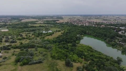 Aerial Flight Forward Over Green Fields and Lake in Gniezno Stock Footage 325816382