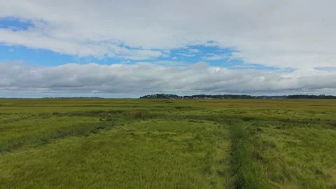 Aerial Flight Forward Over Ipswich Salt Marsh and Tidal Creek Stock Footage 345563235