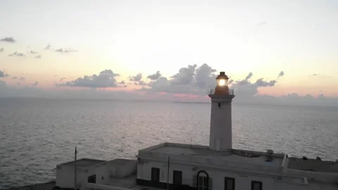 Aerial flight forward over a lighthouse during beautiful sunset. Sicily, Italy. Video stock 134622332