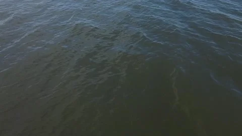 Aerial flight forwards starting with camera looking down at water and panning up Stock Footage 151975498