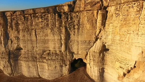 Aerial flight going in between high rock structures cave with a bird flying Stock Footage 106025696