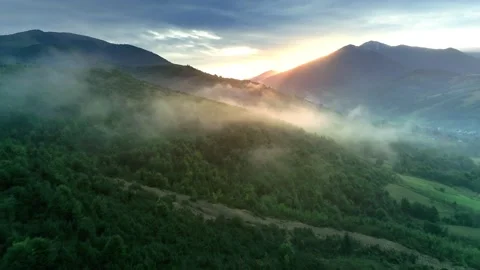Aerial flight inside morning clouds high in the mountains during the golden hour Stock Footage 154064810