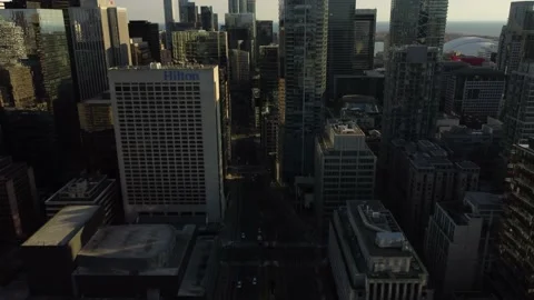 Aerial flight looking down at University Avenue in Toronto with the skyline in t Stock Footage 151922466
