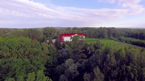 AERIAL: Flight low over the forest towards the big holiday house. Stock Footage 82469260