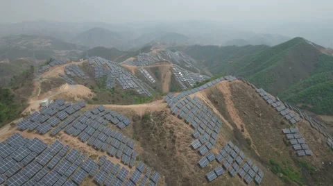 Aerial flight massive solar panel power project in mountains Northern China Stock Footage 67527307