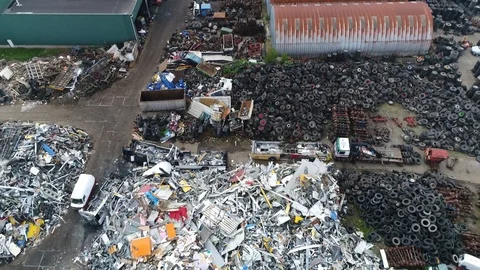 Aerial flight moving backwards over junkyard 4k Stock Footage 97781490