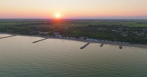 Aerial flight near the beach of Duna Verde (Italy) at beautiful sunset. 4k dci Stock Footage 281348341