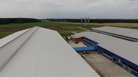 Aerial flight over agricultural complex rooftops Stock Footage 333128503